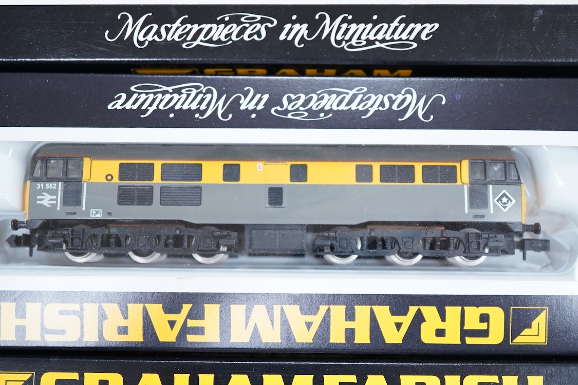 Four boxed Graham Farish N gauge railway Class 31 Co-Co diesel locomotives; a BR, 31 552 (806A), an EWS, 31 466 (806B), a BR, 31 205 (8066) and a Regional Railways, 31 421 (8067).